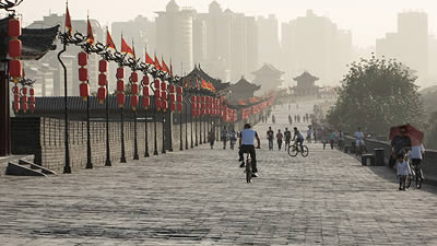 man on bicycle riding along the walls of Xi’an