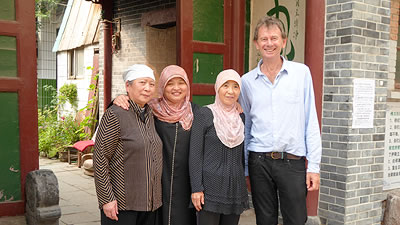 Michael Wood standing with 3 Muslim Chinese women