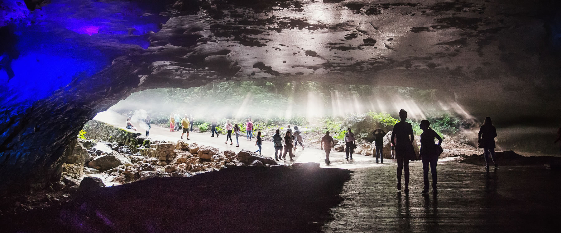 people walking in a large cavern