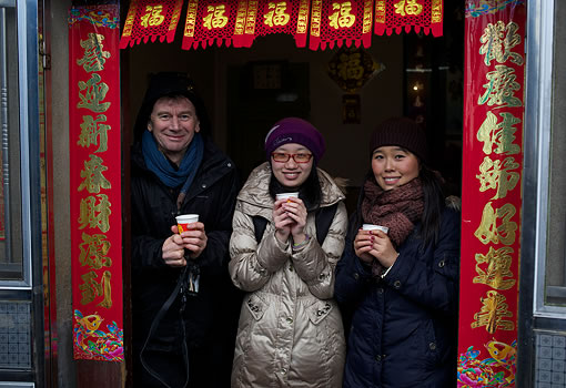 3 crew members holding paper cups