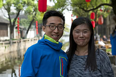 2 crew member with red lanterns and canal in background
