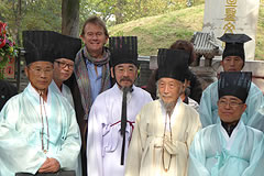 Michael Wood standing with men dressed in ceremonial clothing