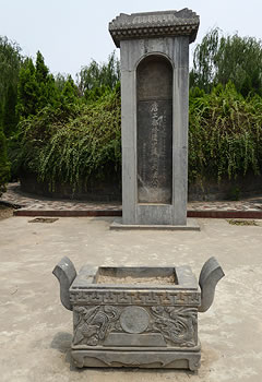 Stone square urn and small monument with Chinese writing